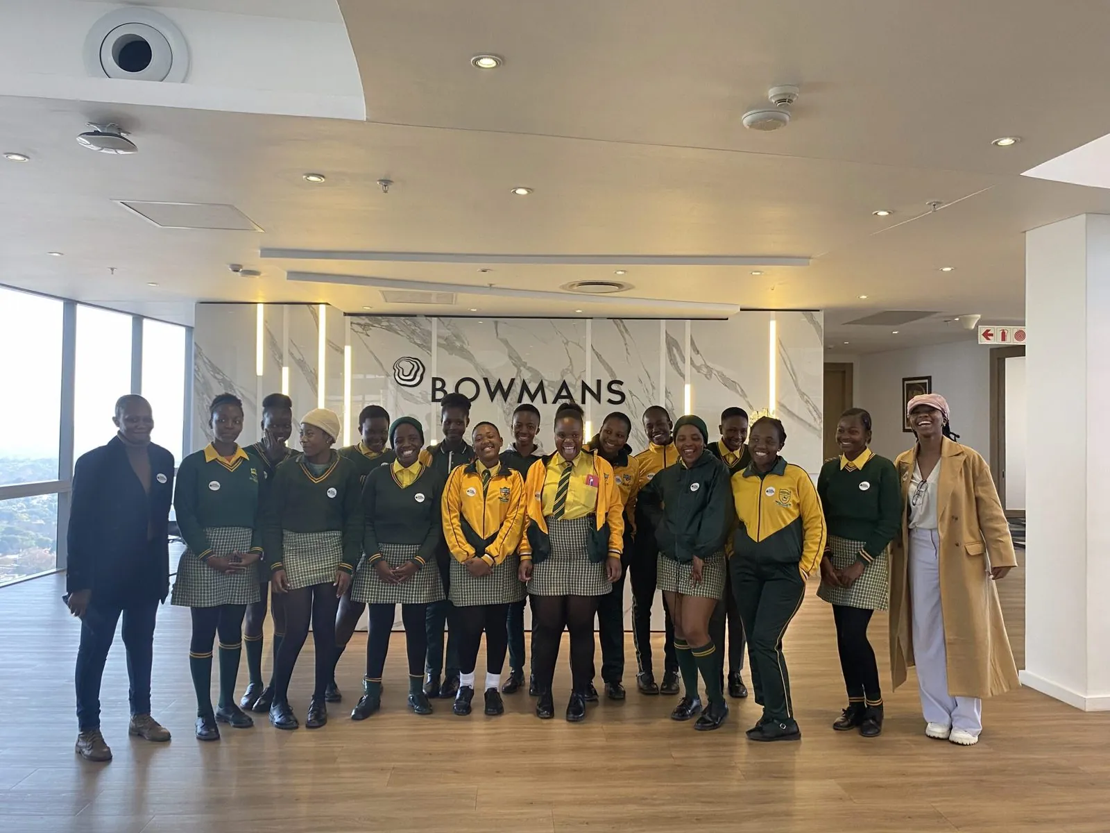 Schoolgirls with their hosts in the reception of a law firm on a workplace visit